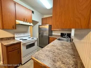 a kitchen with a stove and a refrigerator
