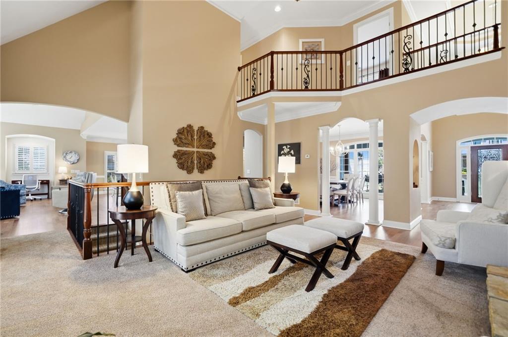4147 Gold Mill Ridge Canton, GA 30114 - Photo 13 of 93 a living room with furniture a rug and a chandelier