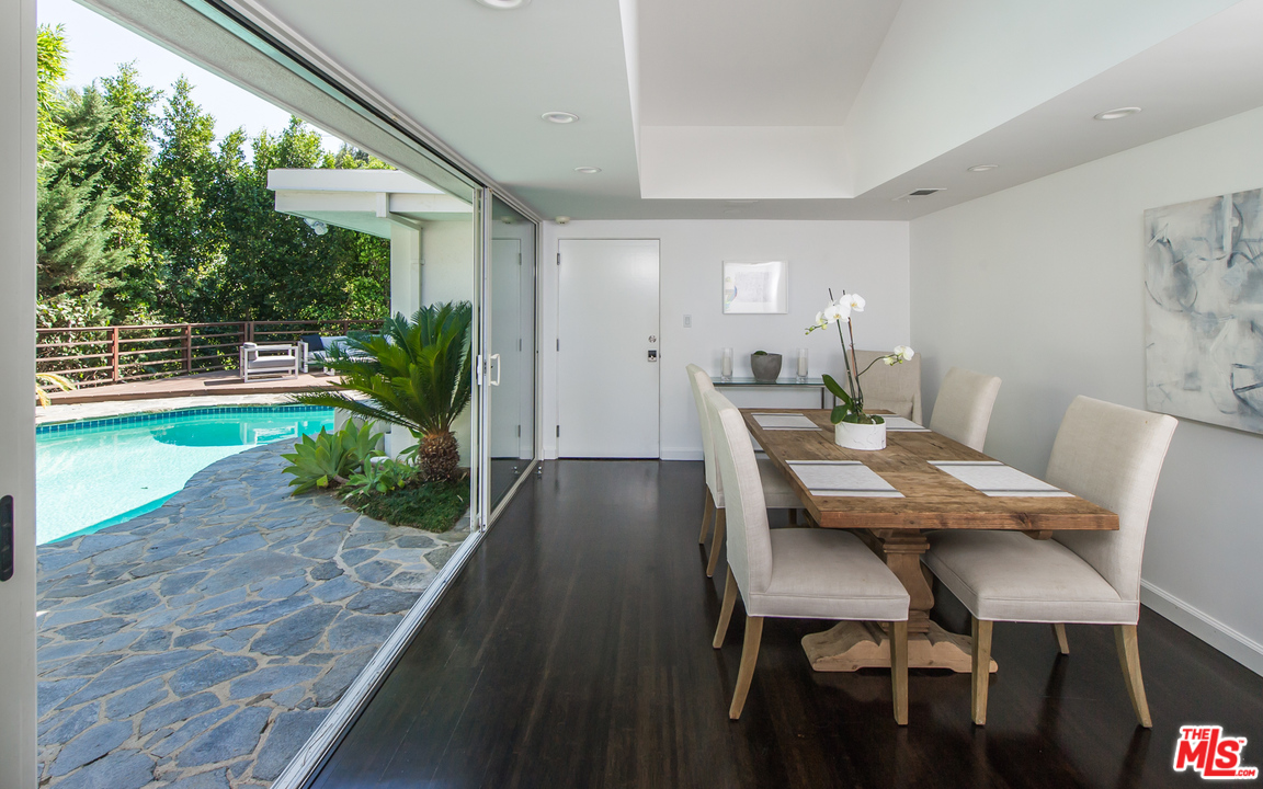 1908 North Beverly Drive Beverly Hills, CA 90210 - Photo 14 of 32 a view of a dining room with furniture and a potted plant