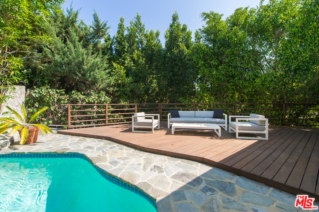 1908 North Beverly Drive Beverly Hills, CA 90210 - Photo 20 of 32 a view of a chairs and table on the wooden deck