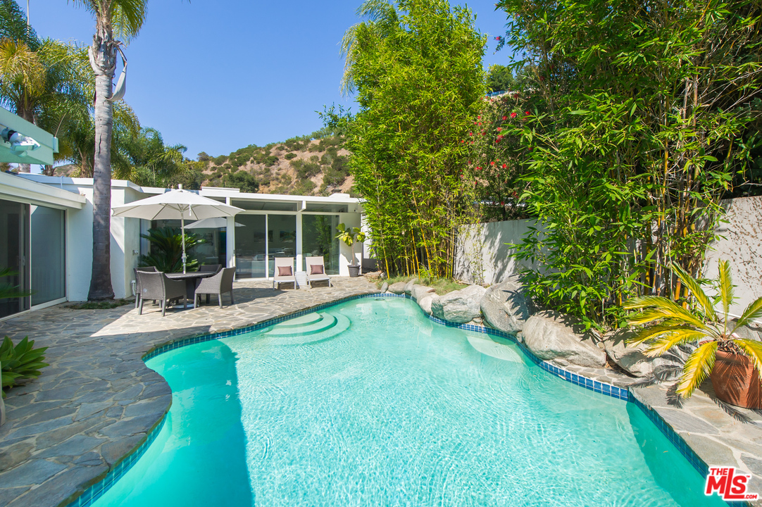 1908 North Beverly Drive Beverly Hills, CA 90210 - Photo 22 of 32 a view of a house with backyard sitting area and garden