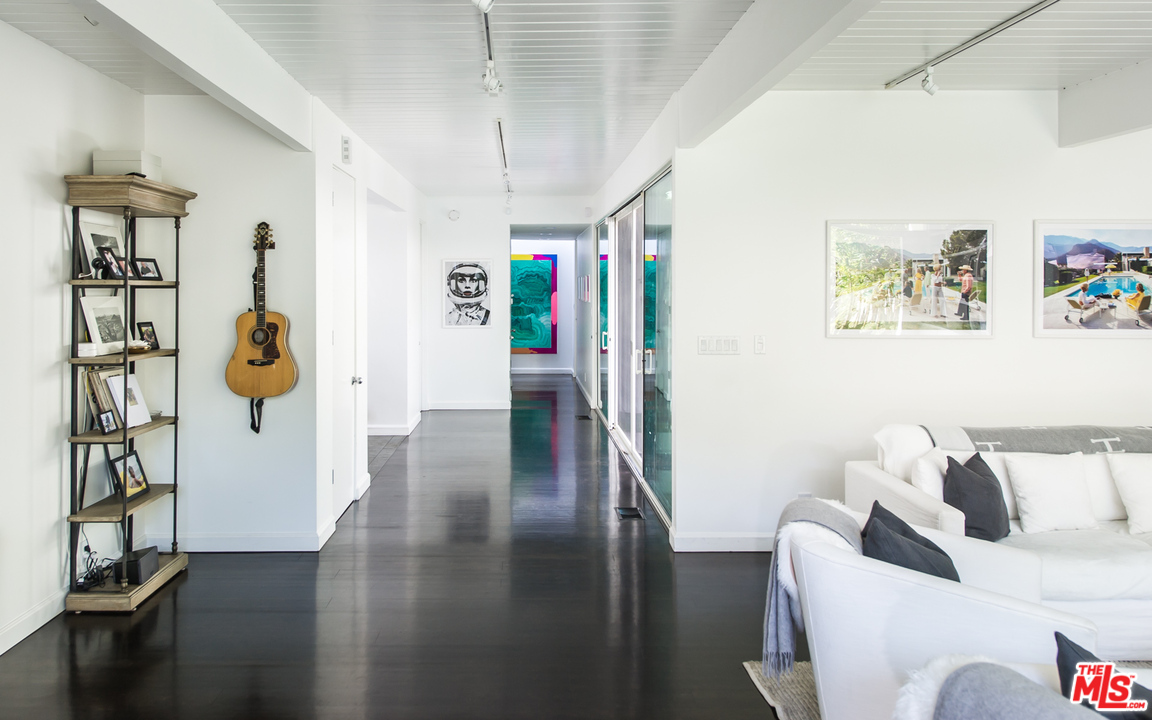 1908 North Beverly Drive Beverly Hills, CA 90210 - Photo 23 of 32 a view of a hallway with furniture and wooden floor