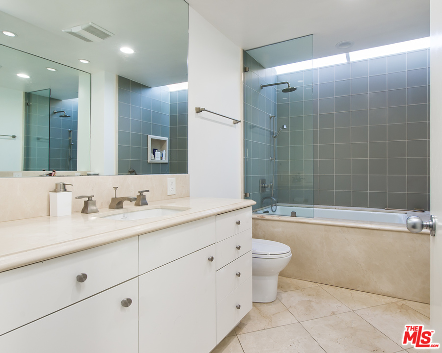 1908 North Beverly Drive Beverly Hills, CA 90210 - Photo 25 of 32 a bathroom with a double vanity sink toilet mirror and bathtub