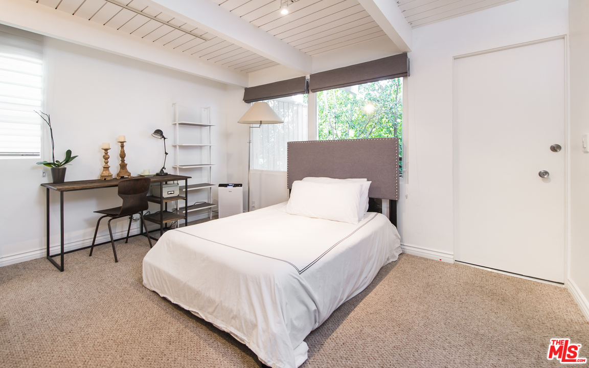 1908 North Beverly Drive Beverly Hills, CA 90210 - Photo 31 of 32 a bedroom with bed and window