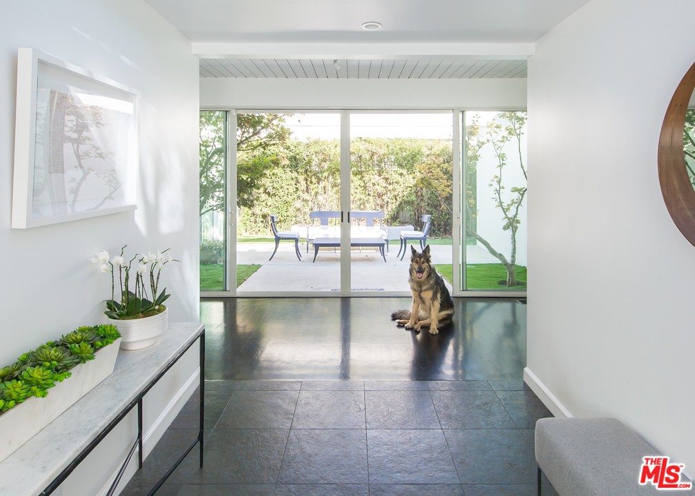 1908 North Beverly Drive Beverly Hills, CA 90210 - Photo 5 of 32 a living room with furniture and a large window