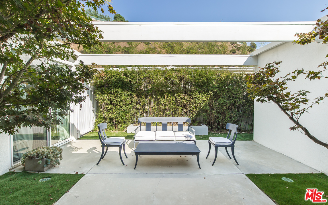 1908 North Beverly Drive Beverly Hills, CA 90210 - Photo 6 of 32 a outdoor sitting area with furniture and a yard