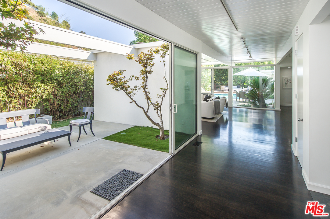 1908 North Beverly Drive Beverly Hills, CA 90210 - Photo 7 of 32 a living room with furniture and a table