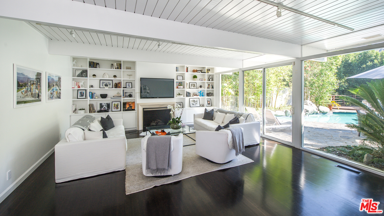 1908 North Beverly Drive Beverly Hills, CA 90210 - Photo 9 of 32 a living room with fireplace furniture and a large window