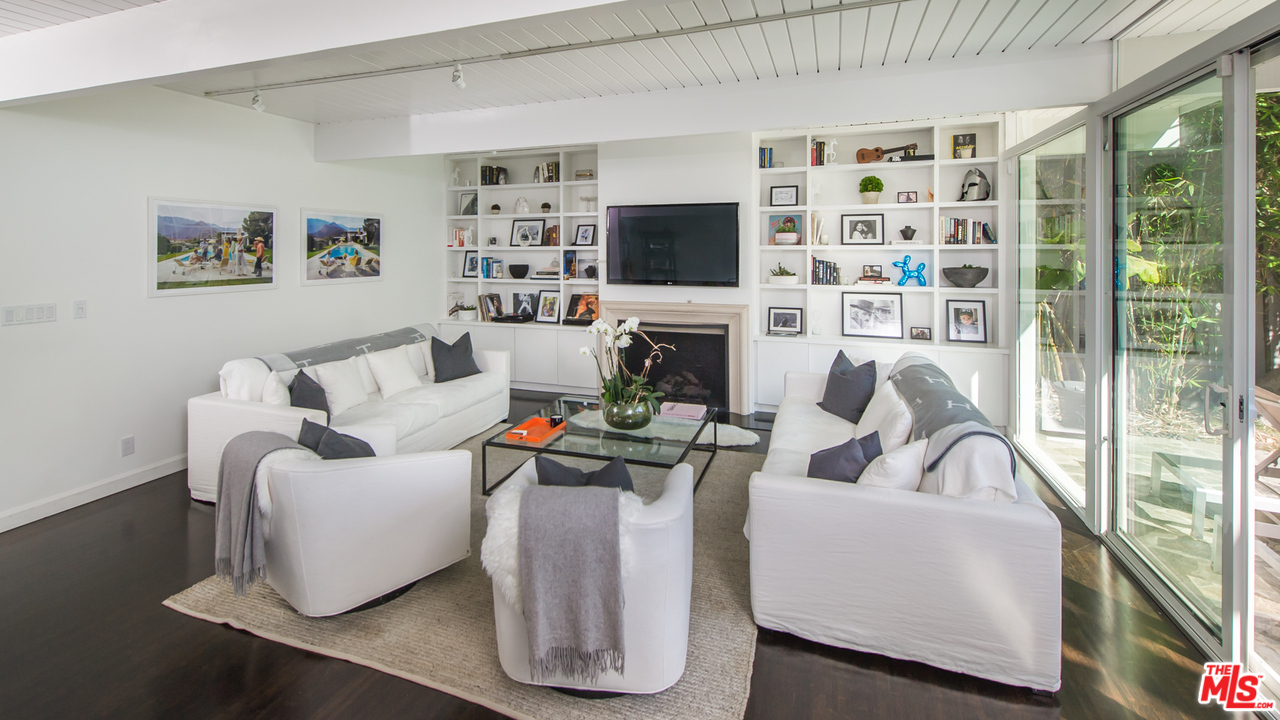 1908 North Beverly Drive Beverly Hills, CA 90210 - Photo 10 of 32 a living room with furniture a flat screen tv and a floor to ceiling window