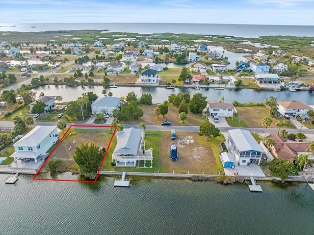 an aerial view of residential houses with outdoor space and lake view