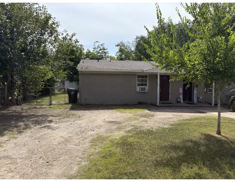 1213 8th Street Rosenberg, TX 77471 - Photo 1 of 7 a house with trees in front of it