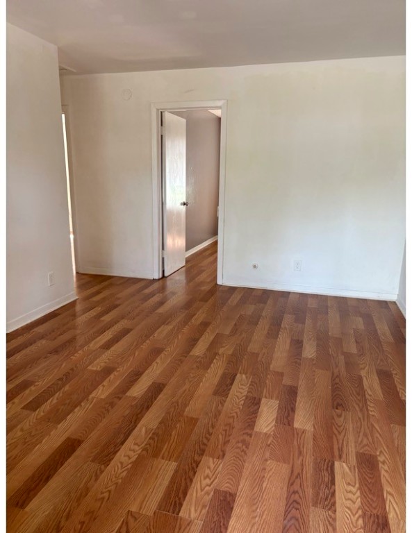 1213 8th Street Rosenberg, TX 77471 - Photo 2 of 7 a view of an empty room with wooden floor and closet