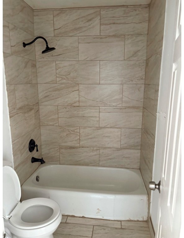 1213 8th Street Rosenberg, TX 77471 - Photo 7 of 7 a bathroom with a bathtub a toilet and a shower
