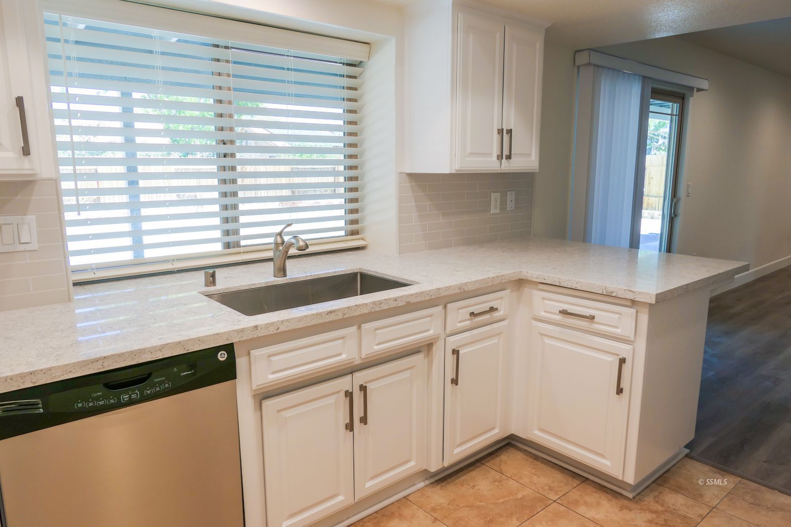 736 West Howell Avenue Ridgecrest, CA 93555 - Photo 19 of 50 a kitchen with white cabinets and a window