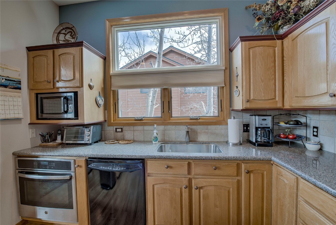 43 Lacy Drive Silverthorne, CO 80498 - Photo 11 of 35 a kitchen with granite countertop a sink a stove and cabinets