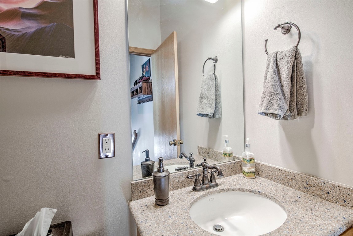 43 Lacy Drive Silverthorne, CO 80498 - Photo 19 of 35 a bathroom with a granite countertop sink and a mirror