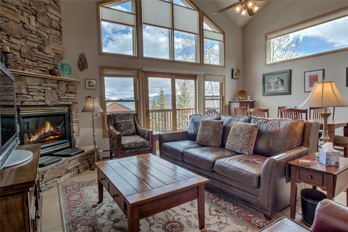 43 Lacy Drive Silverthorne, CO 80498 - Photo 2 of 35 a living room with furniture a flat screen tv and a fireplace