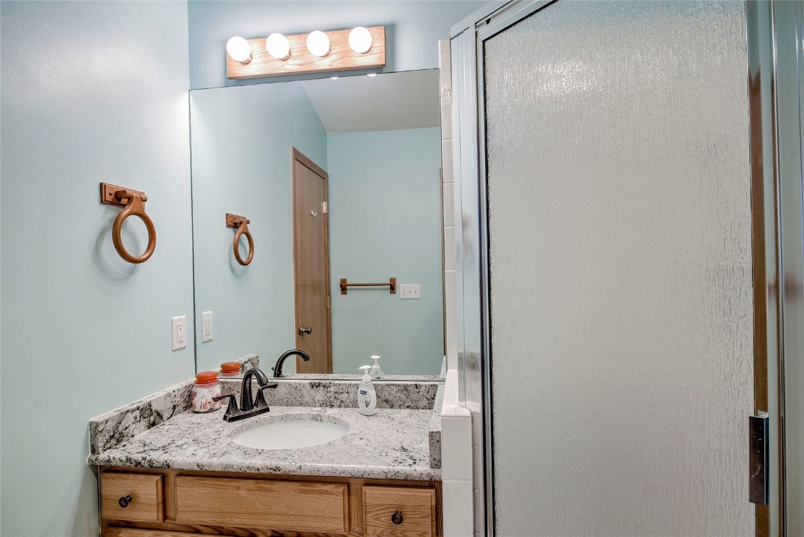 43 Lacy Drive Silverthorne, CO 80498 - Photo 23 of 35 a bathroom with a granite countertop sink and a mirror