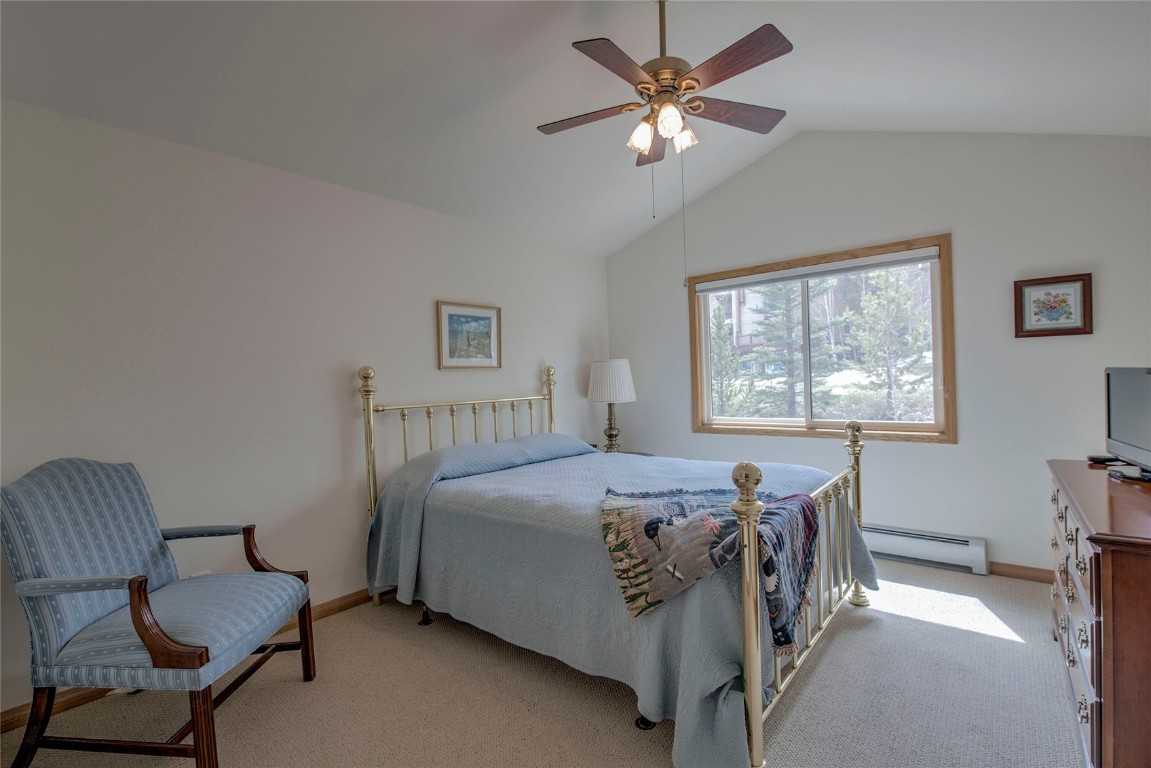 43 Lacy Drive Silverthorne, CO 80498 - Photo 24 of 35 a bedroom with a bed and a chandelier