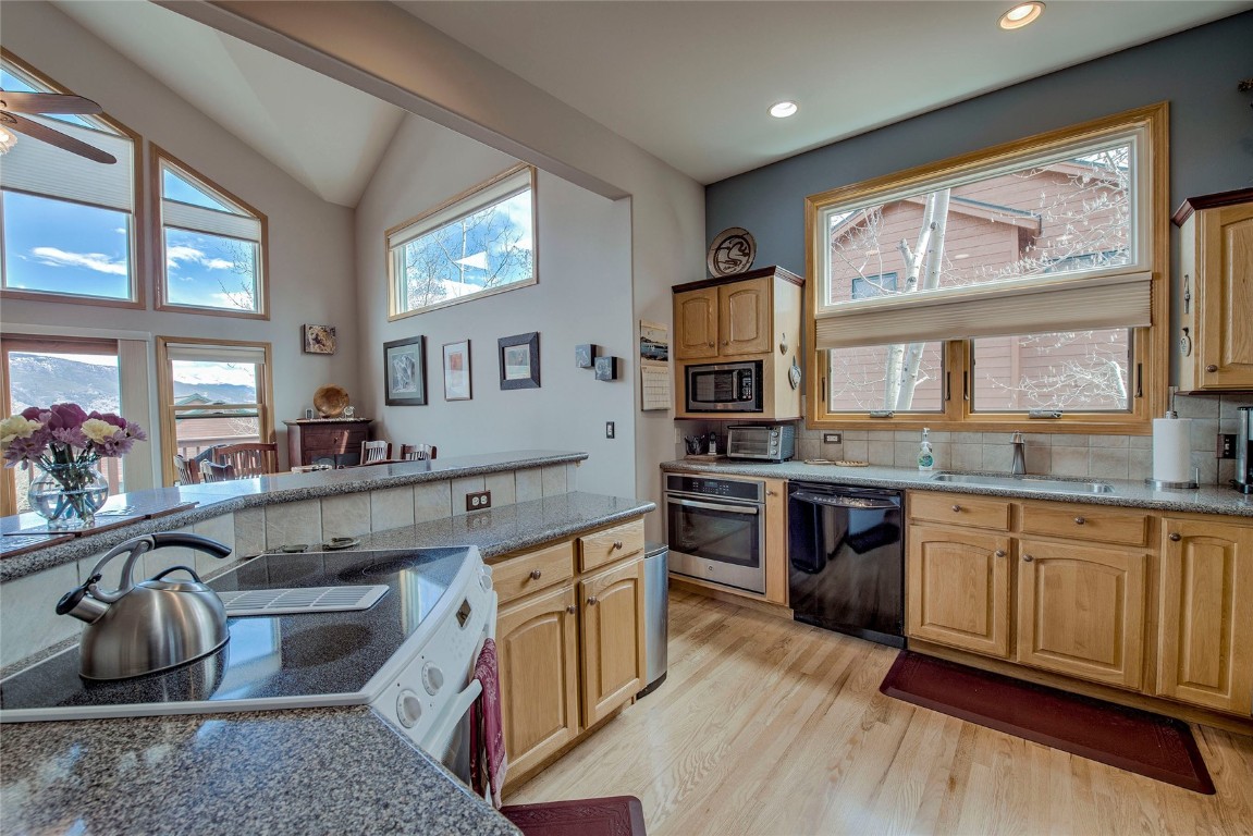 43 Lacy Drive Silverthorne, CO 80498 - Photo 9 of 35 a kitchen with stainless steel appliances granite countertop a stove and a sink