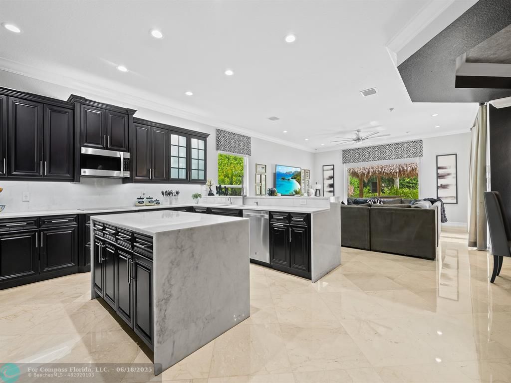 10741 Pine Lodge Trail Davie, FL 33328 - Photo 15 of 48 a kitchen with stainless steel appliances a stove sink and cabinets
