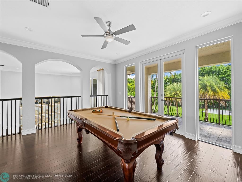 10741 Pine Lodge Trail Davie, FL 33328 - Photo 23 of 48 a room with wooden floor pool table and a chandelier