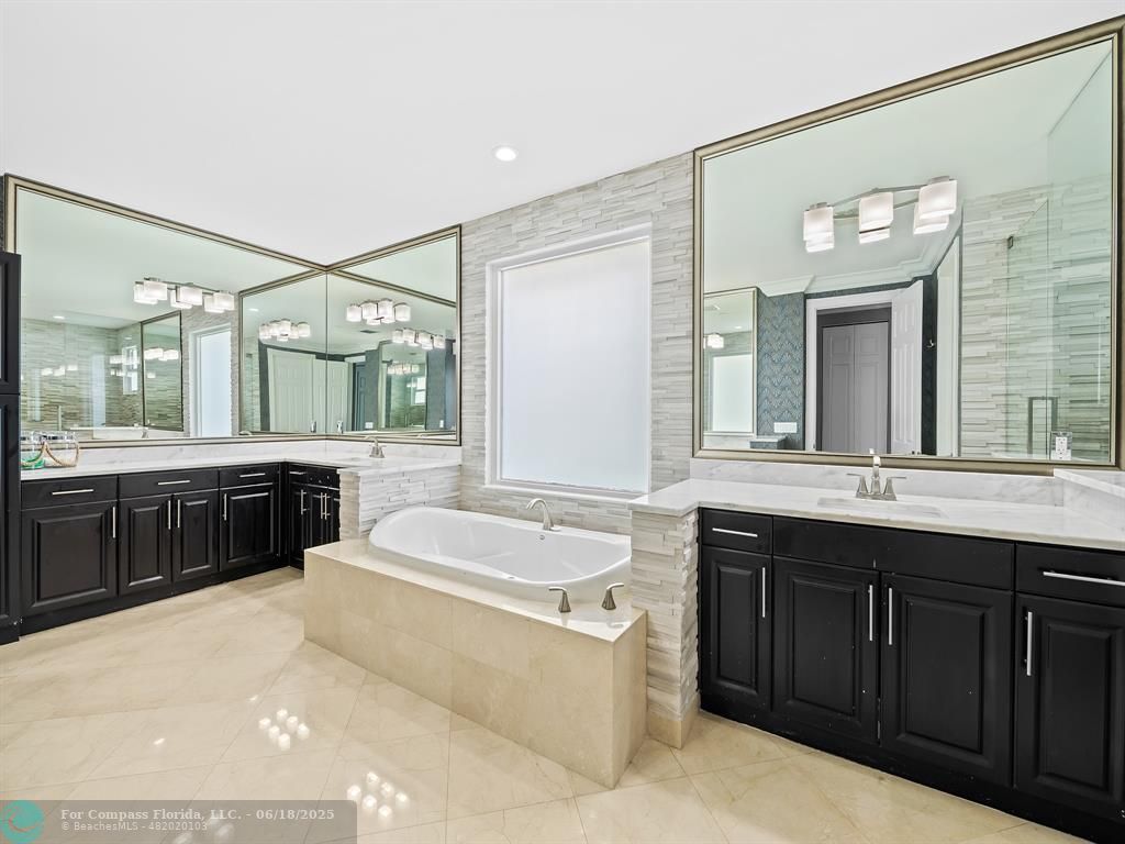 10741 Pine Lodge Trail Davie, FL 33328 - Photo 27 of 48 a spacious bathroom with a tub sink and mirror