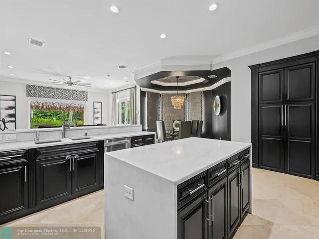 a kitchen with stainless steel appliances a sink and a refrigerator