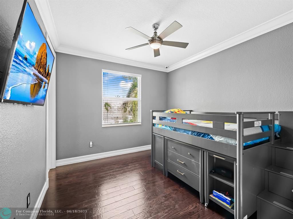 10741 Pine Lodge Trail Davie, FL 33328 - Photo 32 of 48 a view of a bedroom with wooden floor closet and windows
