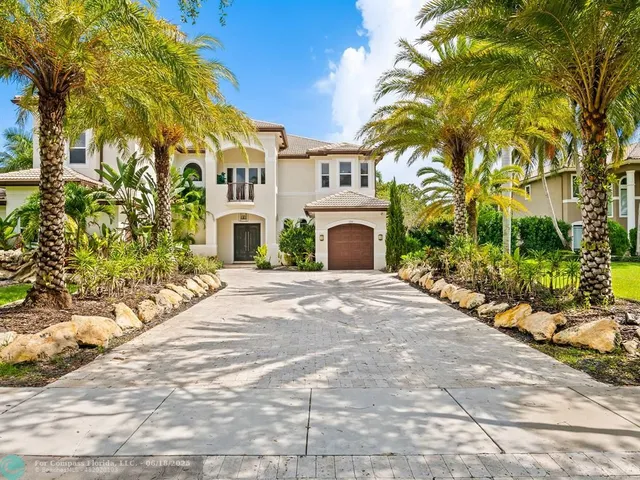 an aerial view of a house with swimming pool and garden space