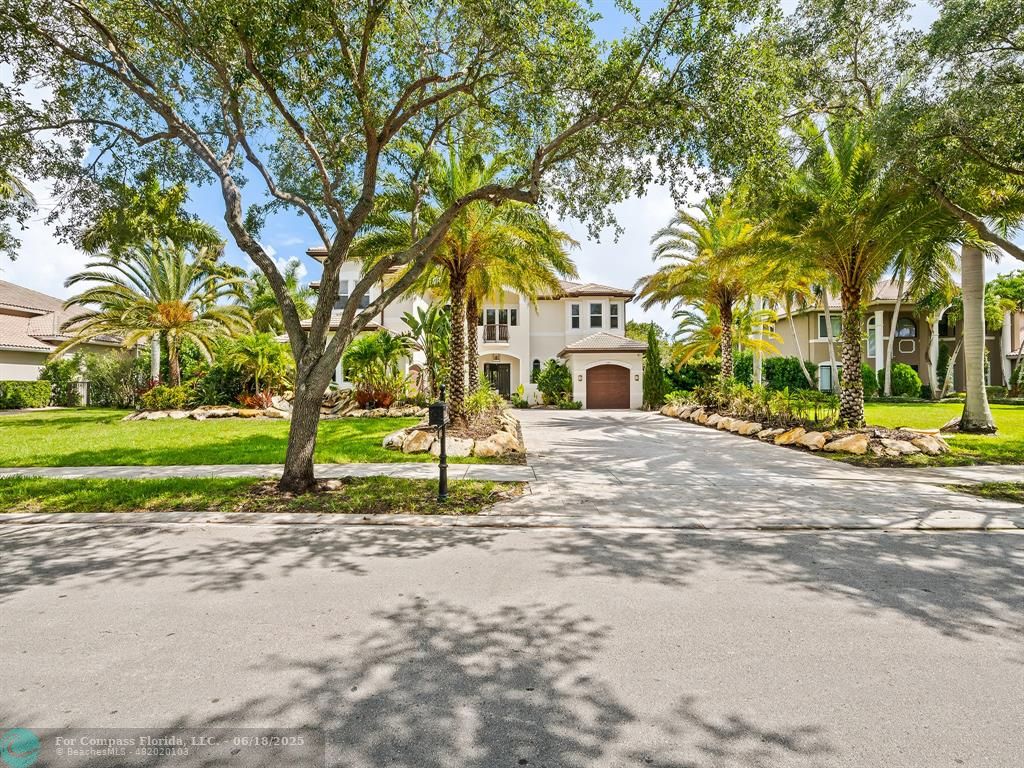 10741 Pine Lodge Trail Davie, FL 33328 - Photo 42 of 48 a view of a house with a small yard and large trees