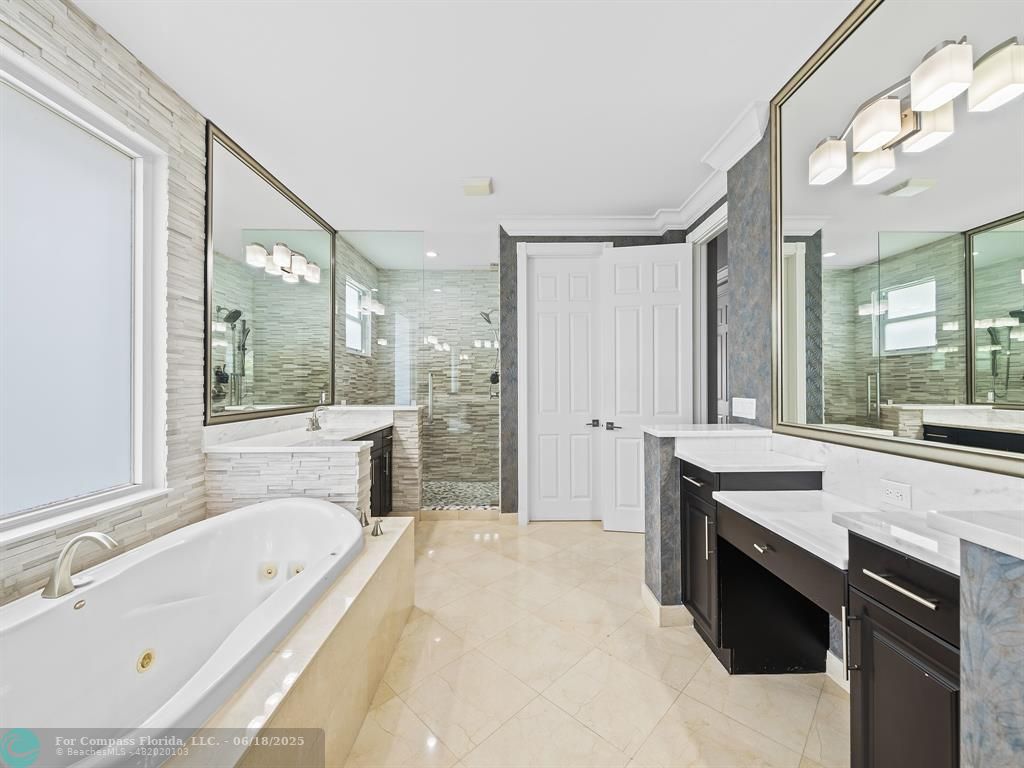 10741 Pine Lodge Trail Davie, FL 33328 - Photo 6 of 48 a spacious bathroom with a tub double vanity sink a mirror and a shower