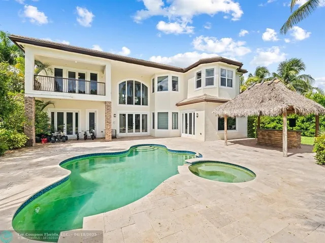 a view of house with swimming pool outdoor seating