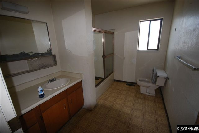 475 Hoge Road Reno, NV 89506 - Photo 6 of 9 a bathroom with a sink a toilet and a mirror