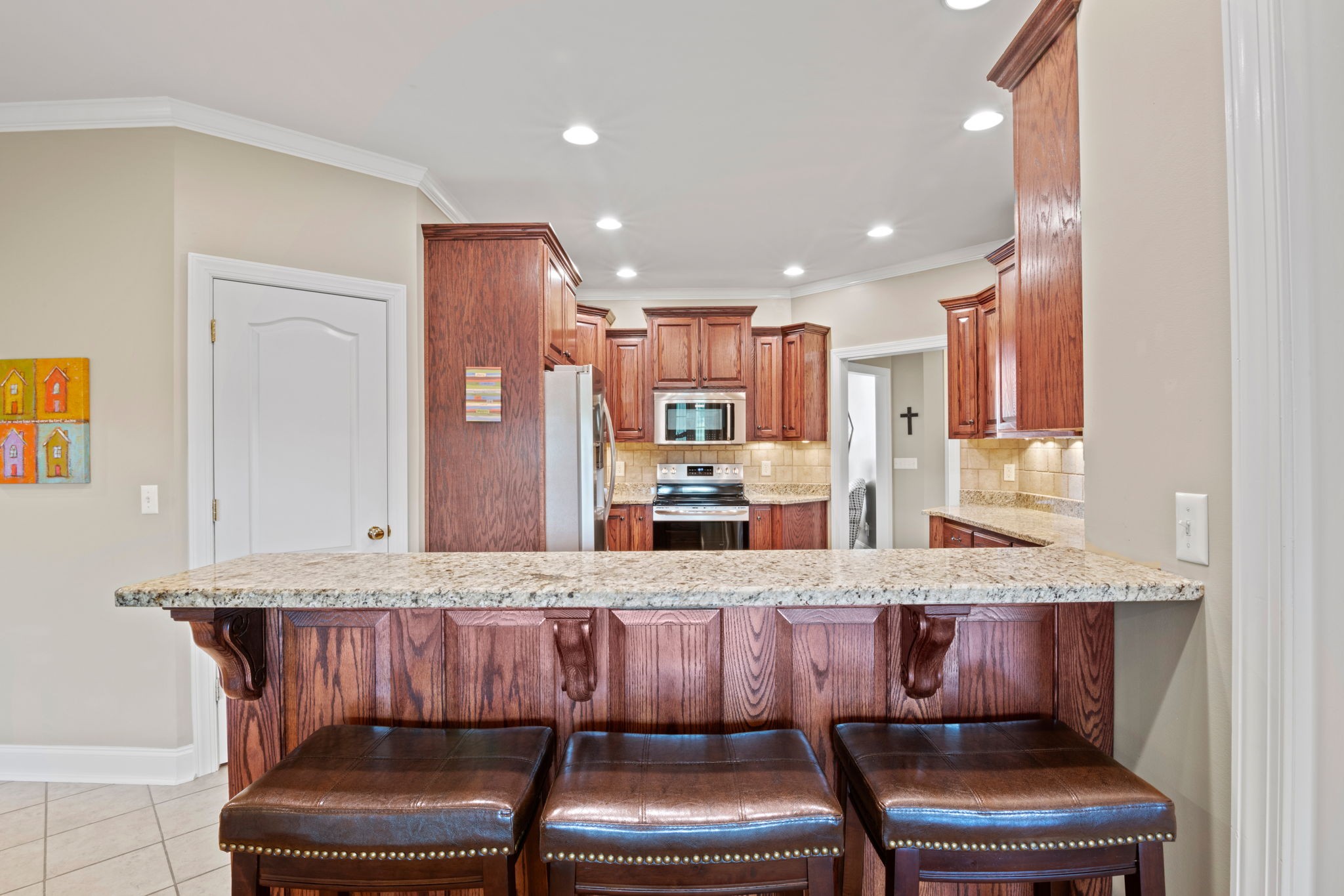 4717 Mt Zion Road Springfield, TN 37172 - Photo 11 of 34 a dining hall with stainless steel appliances kitchen island granite countertop a dining table and chairs with wooden floor