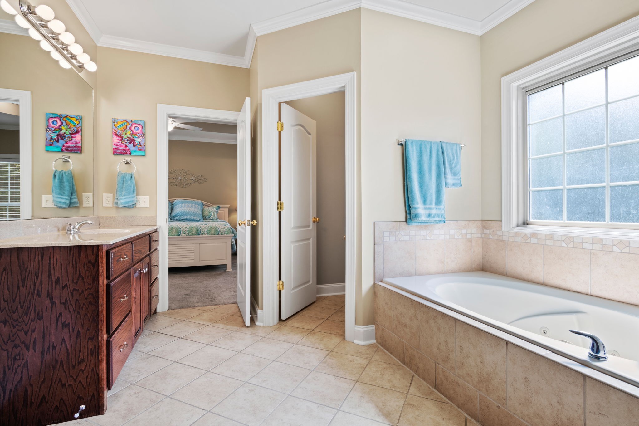 4717 Mt Zion Road Springfield, TN 37172 - Photo 15 of 34 a spacious bedroom with a bed a table and painting on the wall