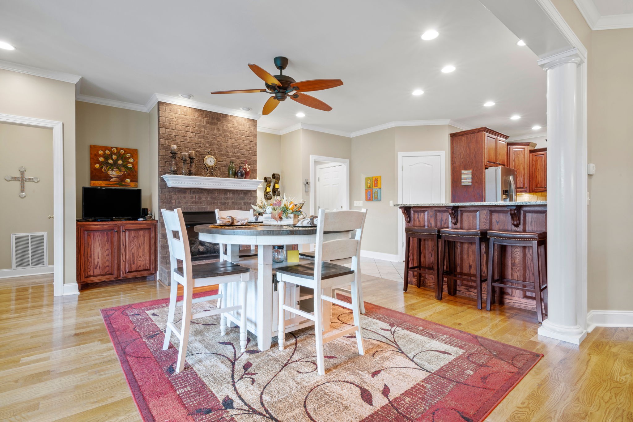 4717 Mt Zion Road Springfield, TN 37172 - Photo 10 of 34 a dining room with furniture a fireplace and wooden floor