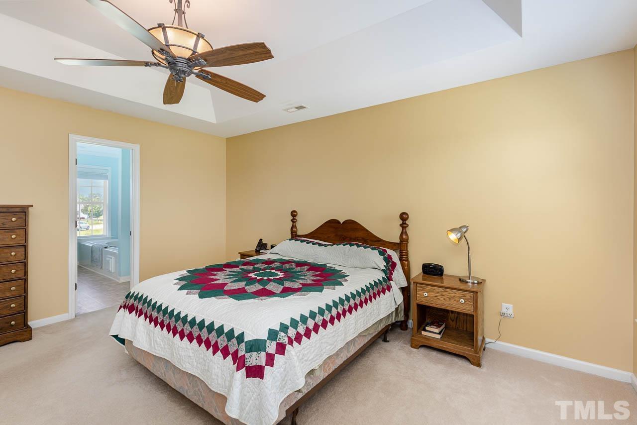 407 Ina Joe Place Willow Spring, NC 27592 - Photo 12 of 26 a bedroom with a bed and a table