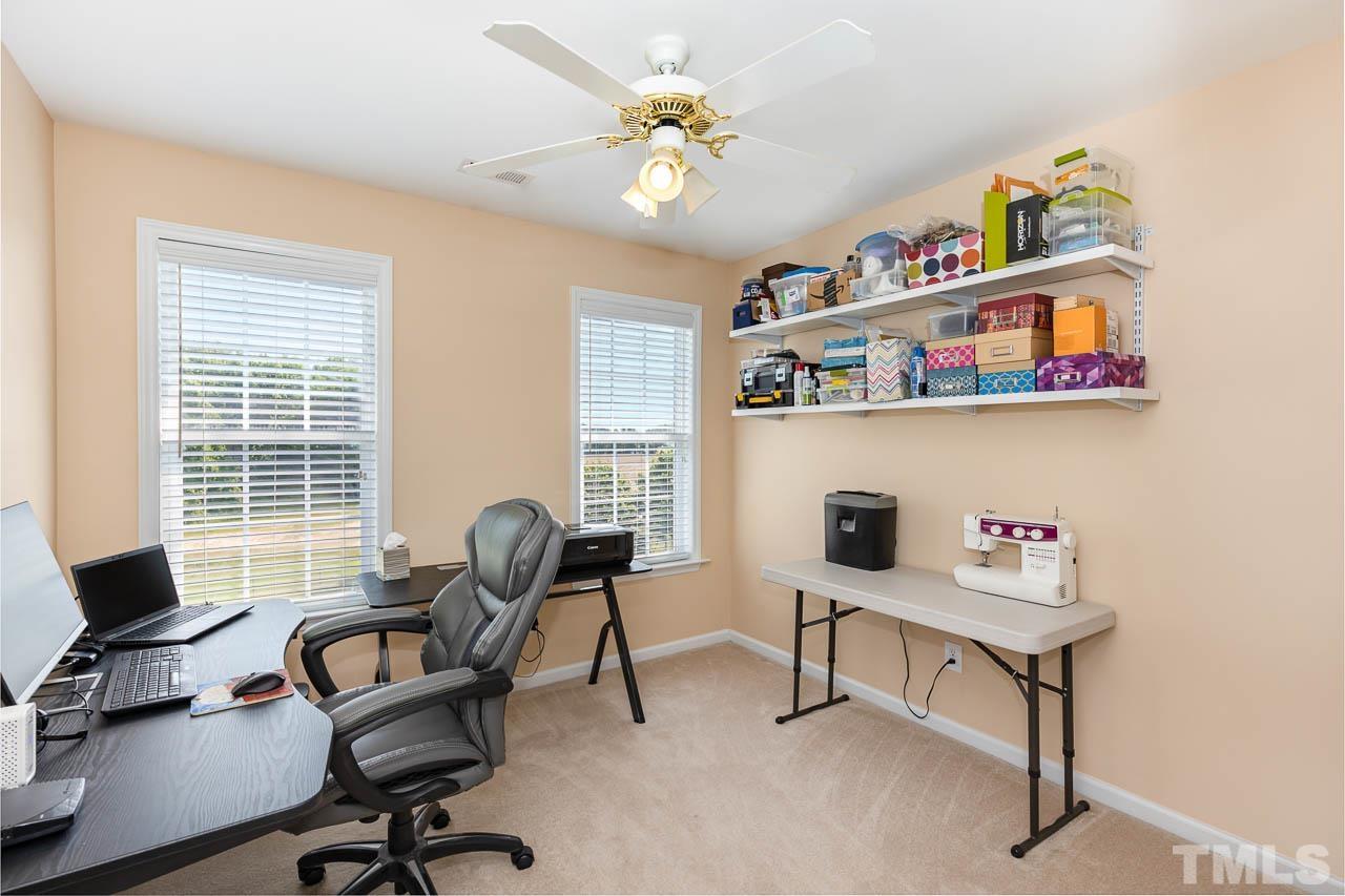 407 Ina Joe Place Willow Spring, NC 27592 - Photo 17 of 26 a view of a workspace with furniture and a window