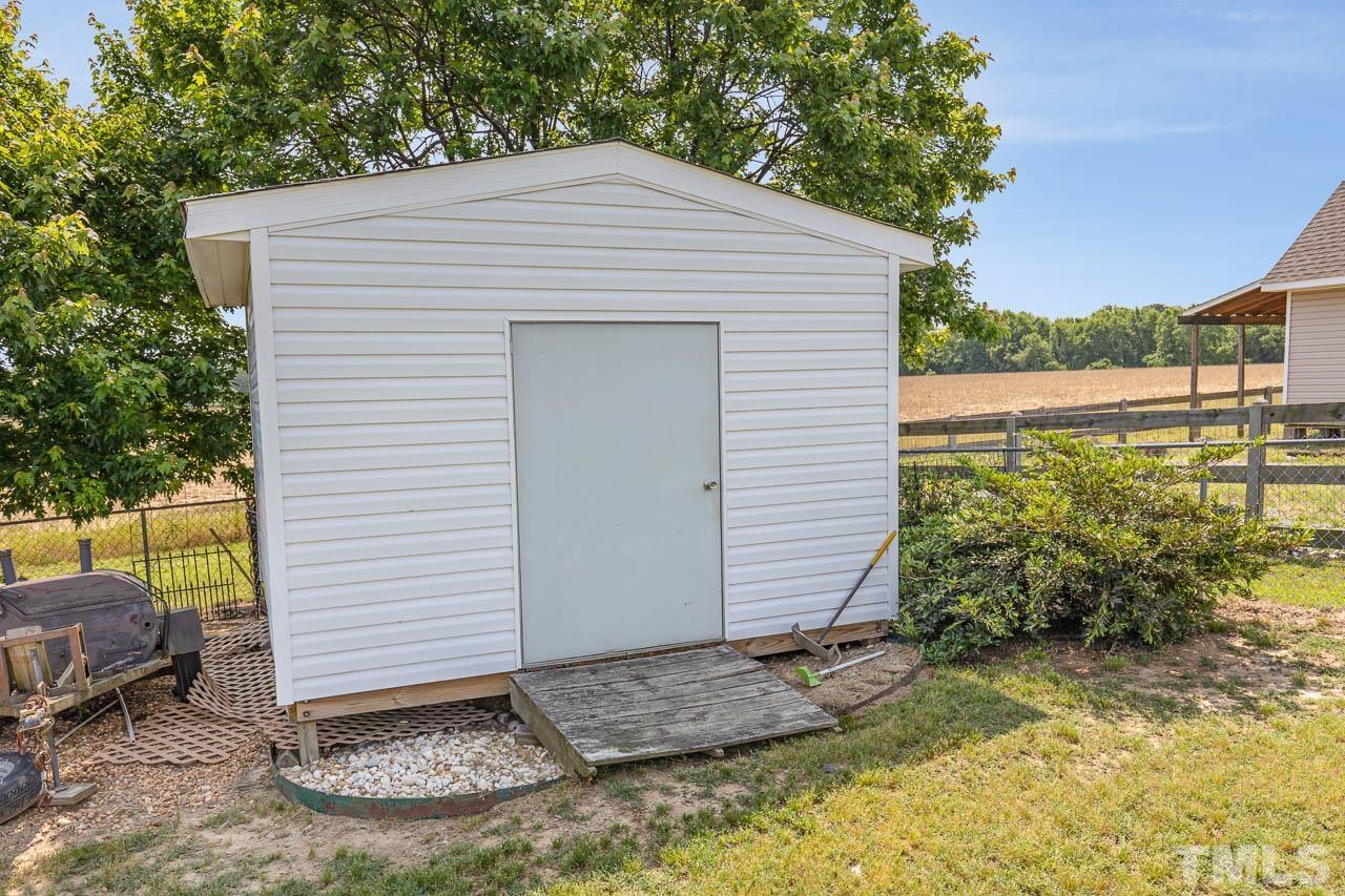 407 Ina Joe Place Willow Spring, NC 27592 - Photo 21 of 26 a view of a small house with wooden fence