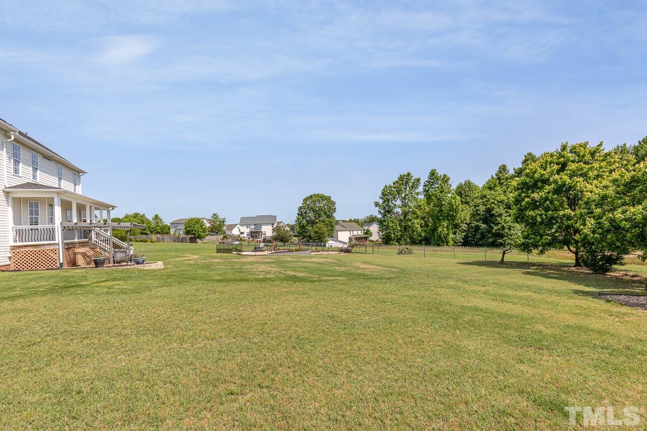 407 Ina Joe Place Willow Spring, NC 27592 - Photo 23 of 26 a view of a lake with a big yard