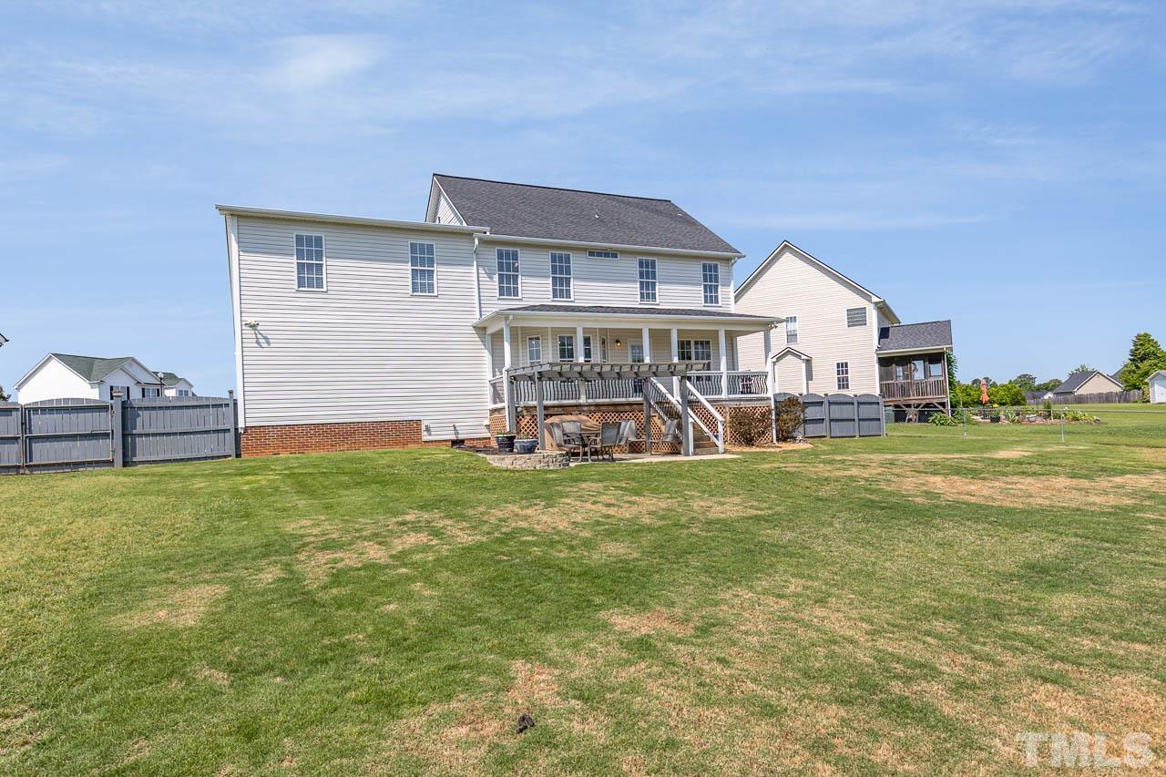 407 Ina Joe Place Willow Spring, NC 27592 - Photo 25 of 26 a view of a house with a backyard porch and sitting area