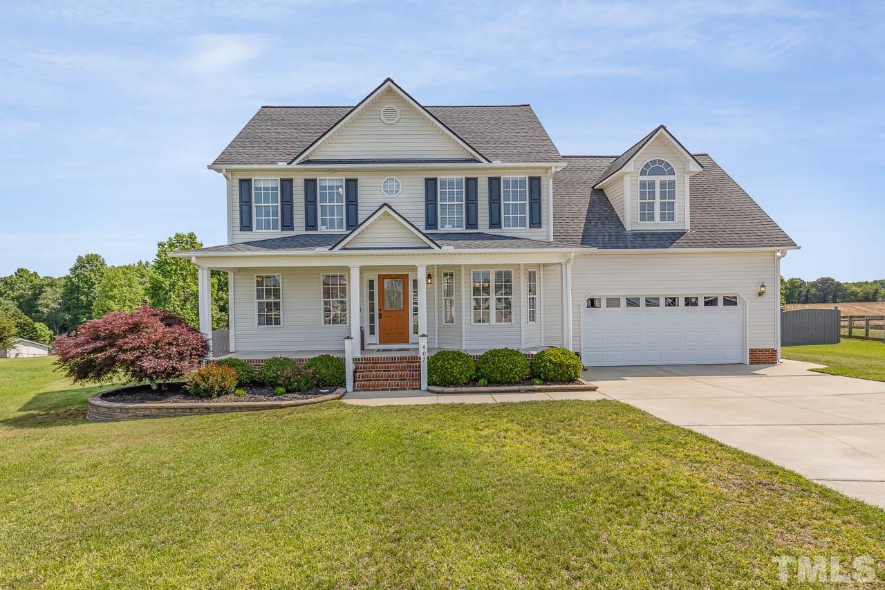407 Ina Joe Place Willow Spring, NC 27592 - Photo 26 of 26 a front view of a house with a yard and potted plants