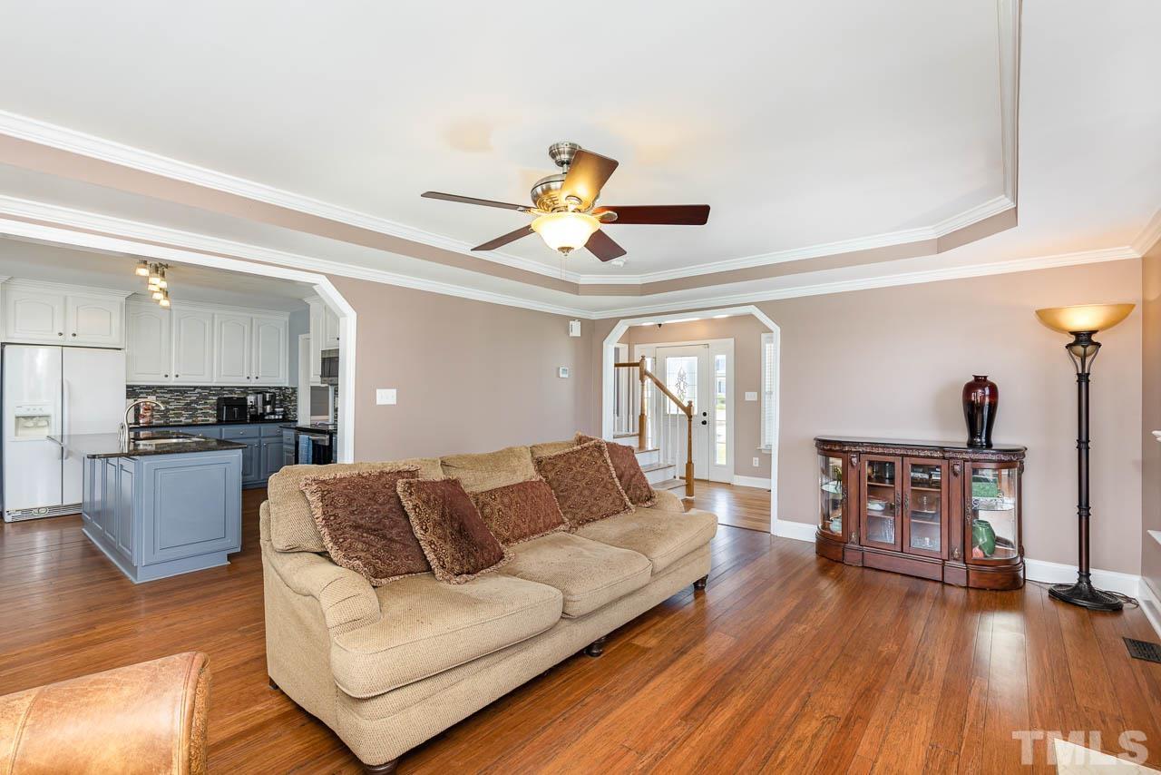 407 Ina Joe Place Willow Spring, NC 27592 - Photo 4 of 26 a living room with furniture and a fireplace