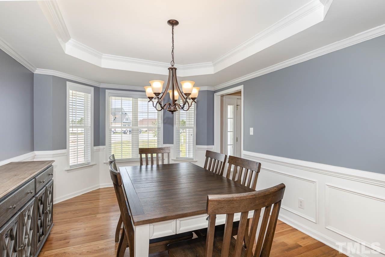 407 Ina Joe Place Willow Spring, NC 27592 - Photo 5 of 26 a view of a dining room with furniture window and wooden floor