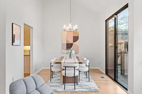 a living room with furniture a fireplace and wall paintings