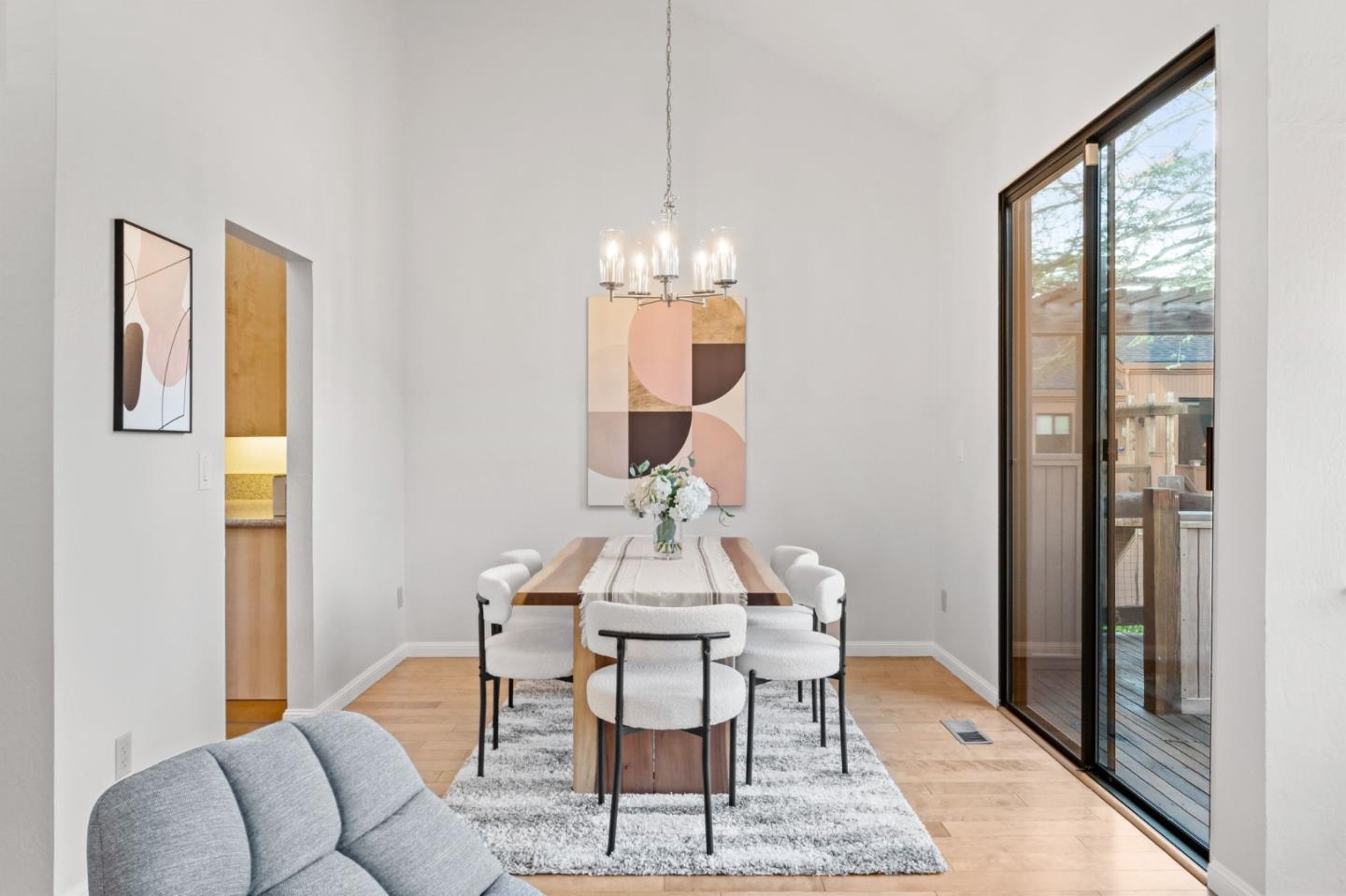 1631 Grant Road Mountain View, CA 94040 - Photo 18 of 51 a dining room with wooden floor a glass table and chairs