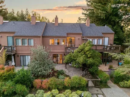 a front view of a house with a yard and outdoor seating