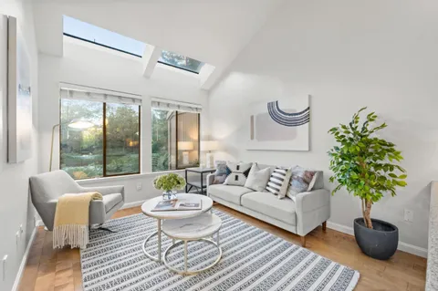 a living room with furniture and a lamp