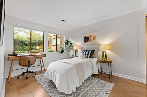 a bedroom with a bed and a desk